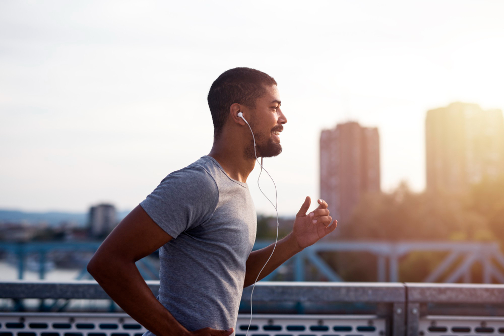 sportsman with earphones running enjoying