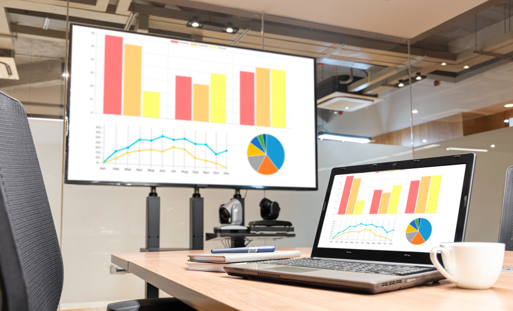 laptop television with mock up chart presentation slideshow meeting room