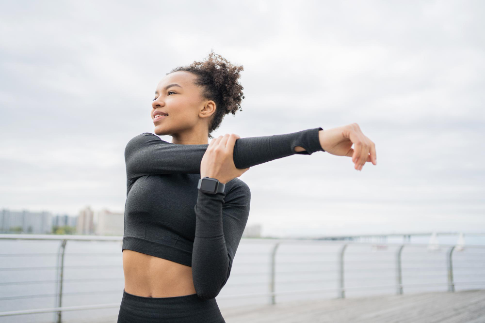 athlete tight tracksuit trains outside fitness watch running app are hand