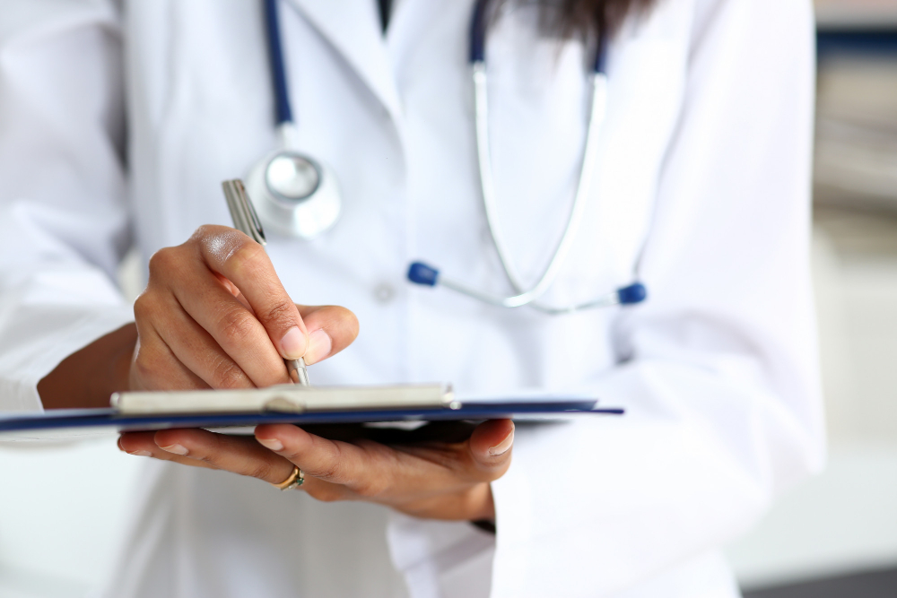 female doctor arm hold silver pen filling