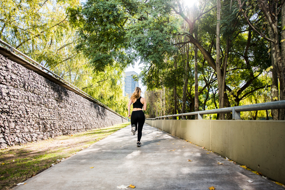 young woman running outdoors with sportswear