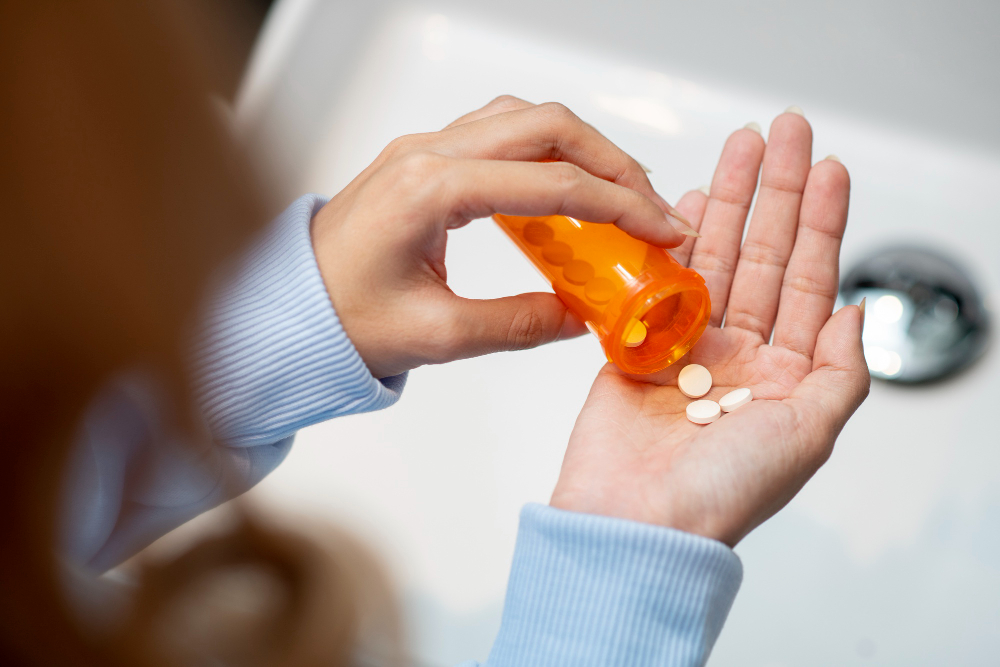 close up hand holding pills
