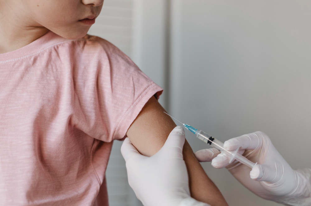 doctor administering vaccine kid