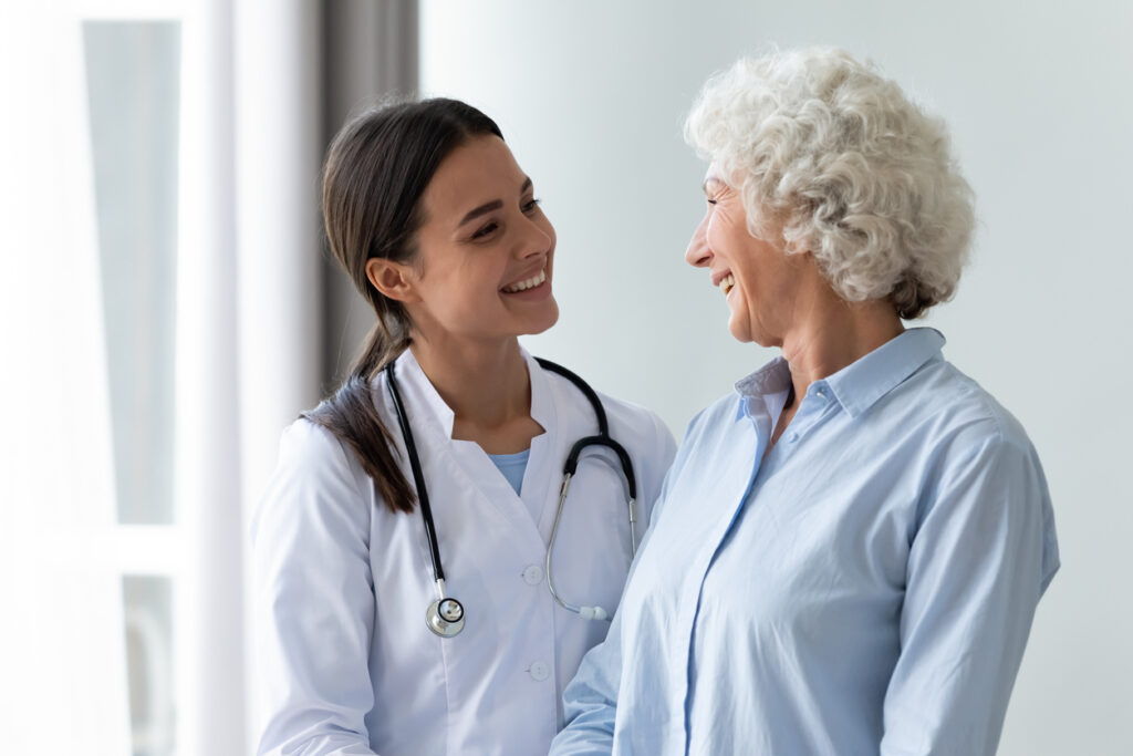 Caring millennial nurse helping middle aged patient at meeting