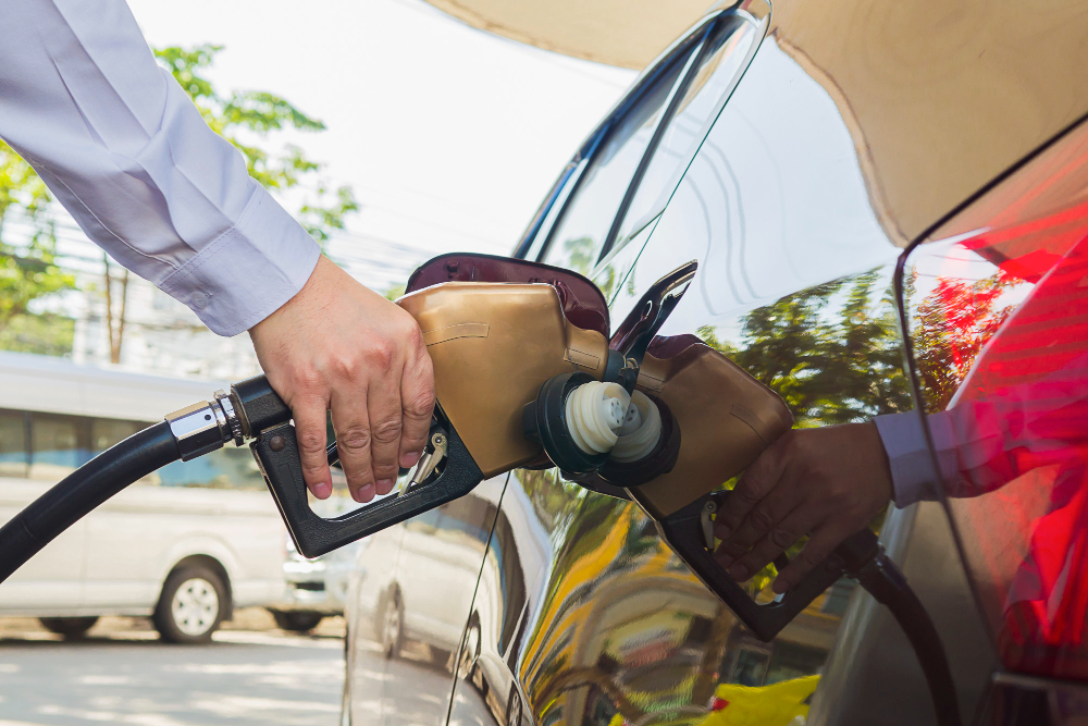 man putting gasoline fuel into his car pump gas station