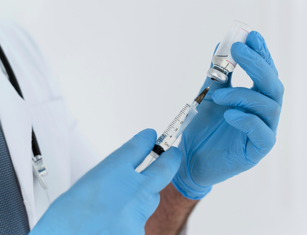 doctor holding syringe close up