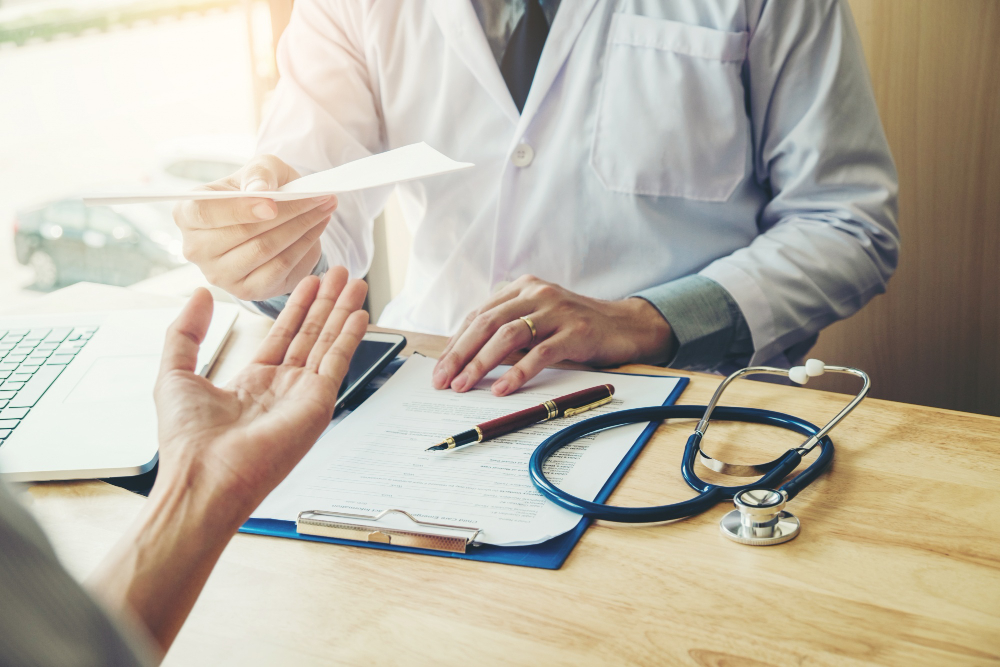 doctor physician writing diagnosis giving medical prescription female patient