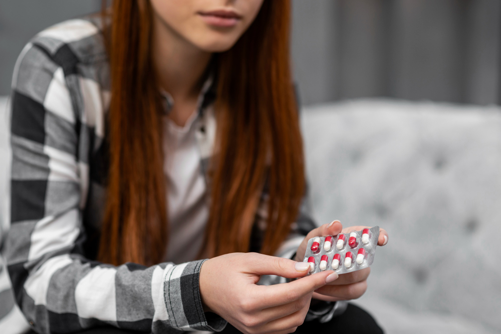 close up woman holding pills
