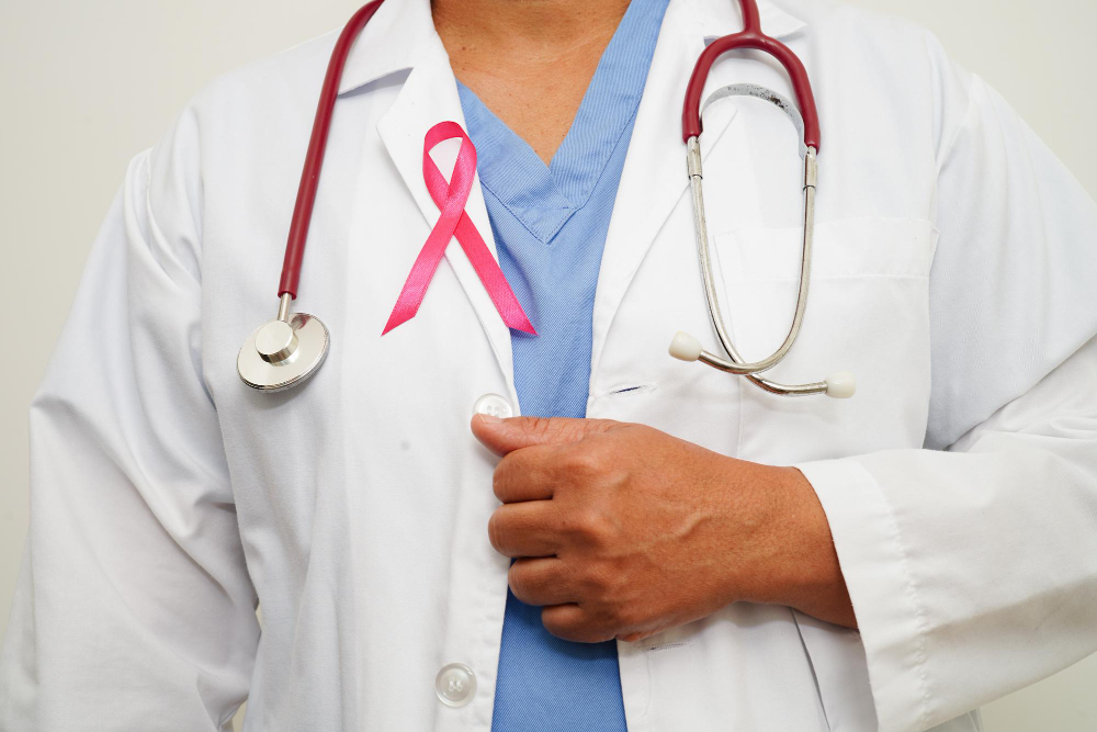 asian woman doctor with pink ribbon world breast cancer day october