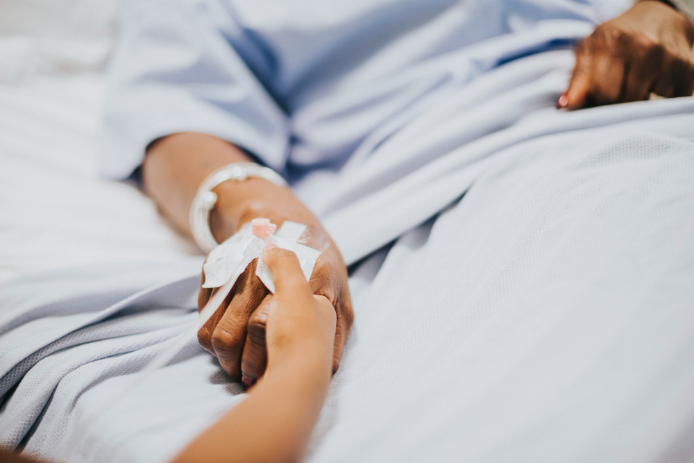 daughter holding her mothers hand hospital