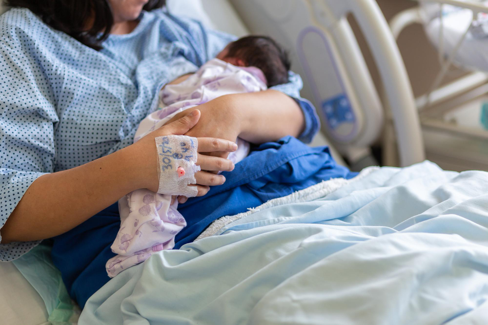 midsection woman breastfeeding baby hospital