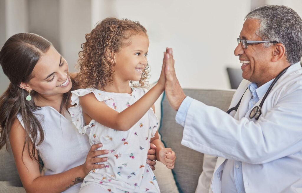 family medical high five with girl doctor consulting hospital room healthcare trust support communication medicine smile with pediatrician consultant with mom child scaled